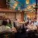 An artist rendering of Guests dining in the Tangled themed Maximus dining room at the Enchanted Summer Restaurant on the Disney Adventure